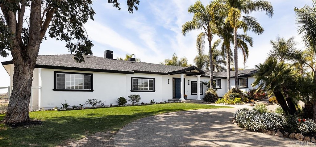 6949 Elfin Oaks Road Escondido, CA 92029 - Photo 2 of 24 a front view of a house with a yard