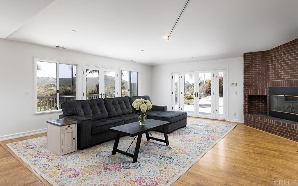 6949 Elfin Oaks Road Escondido, CA 92029 - Photo 5 of 24 a living room with furniture and a fireplace