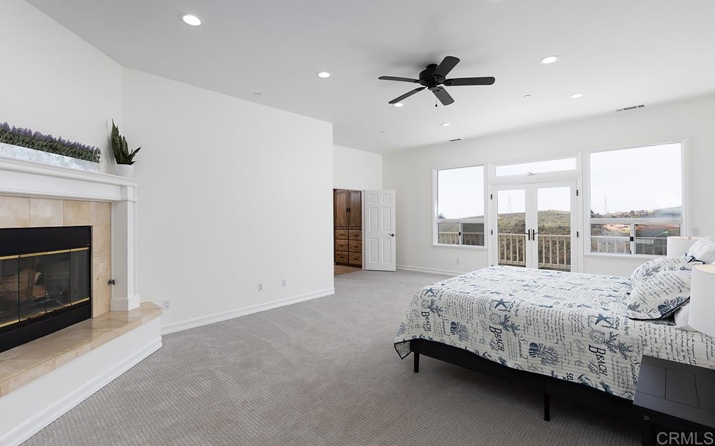 6949 Elfin Oaks Road Escondido, CA 92029 - Photo 9 of 24 a bed sitting in a room next to a balcony next to a window