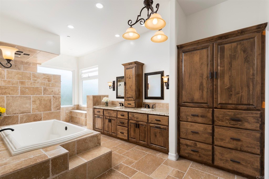 6949 Elfin Oaks Road Escondido, CA 92029 - Photo 10 of 24 a bathroom with a tub sink and mirror