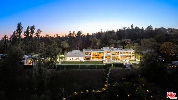 a view of a swimming pool with an outdoor seating and a yard