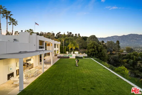 a view of an house with swimming pool and sitting area