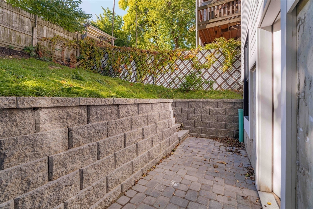 231 Everett Street, Unit 1 Boston, MA 02128 - Photo 16 of 25 a backyard of a house with lots of green space