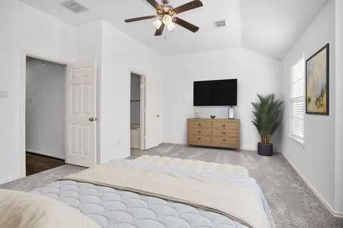 a bedroom with a bed and a flat screen tv