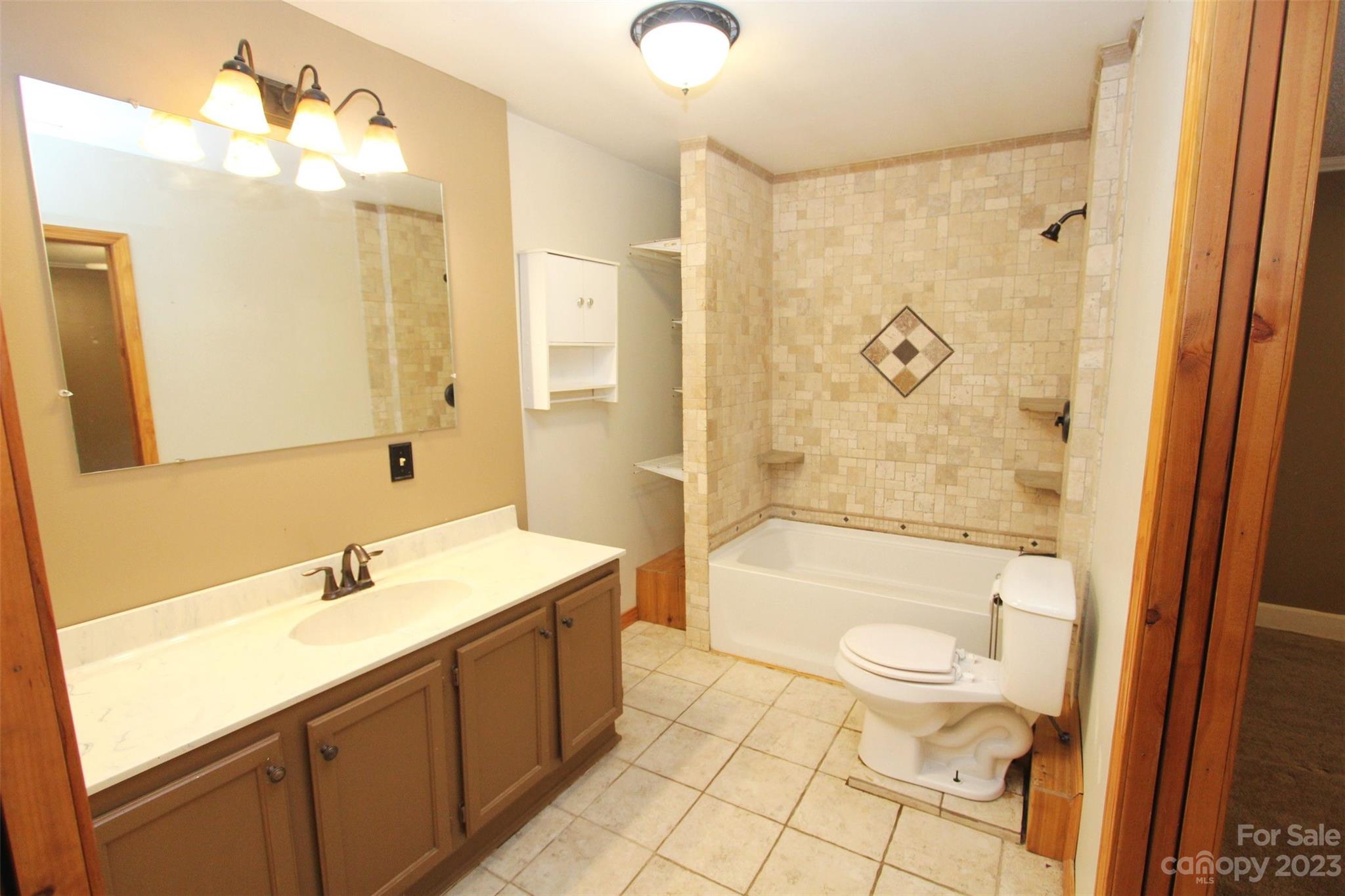 488 Savannah Road Peachland, NC 28133 - Photo 17 of 35 a bathroom with a sink a toilet a mirror and shower