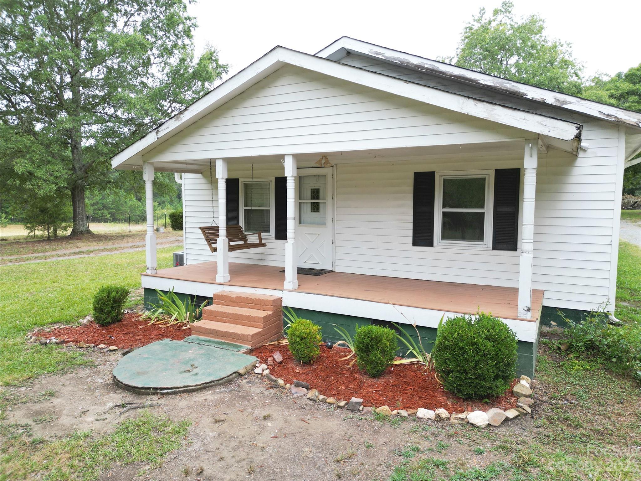 488 Savannah Road Peachland, NC 28133 - Photo 2 of 35 a front view of a house with garden