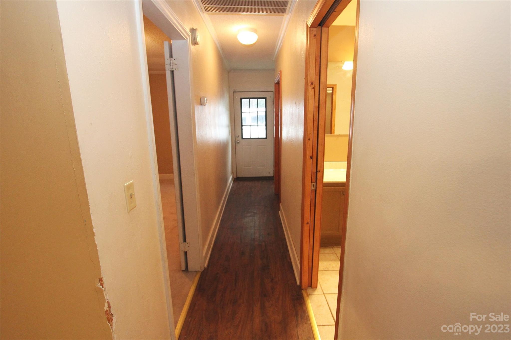 488 Savannah Road Peachland, NC 28133 - Photo 22 of 35 a view of a hallway with wooden floor and glass door