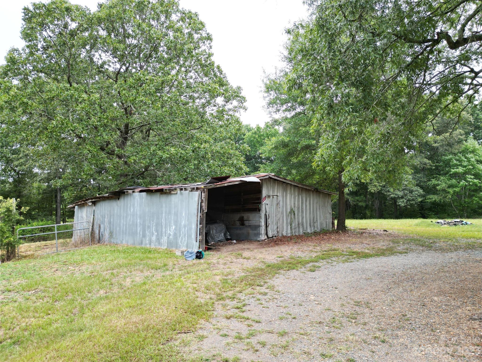 488 Savannah Road Peachland, NC 28133 - Photo 30 of 35 a backyard of a house with a yard and garage