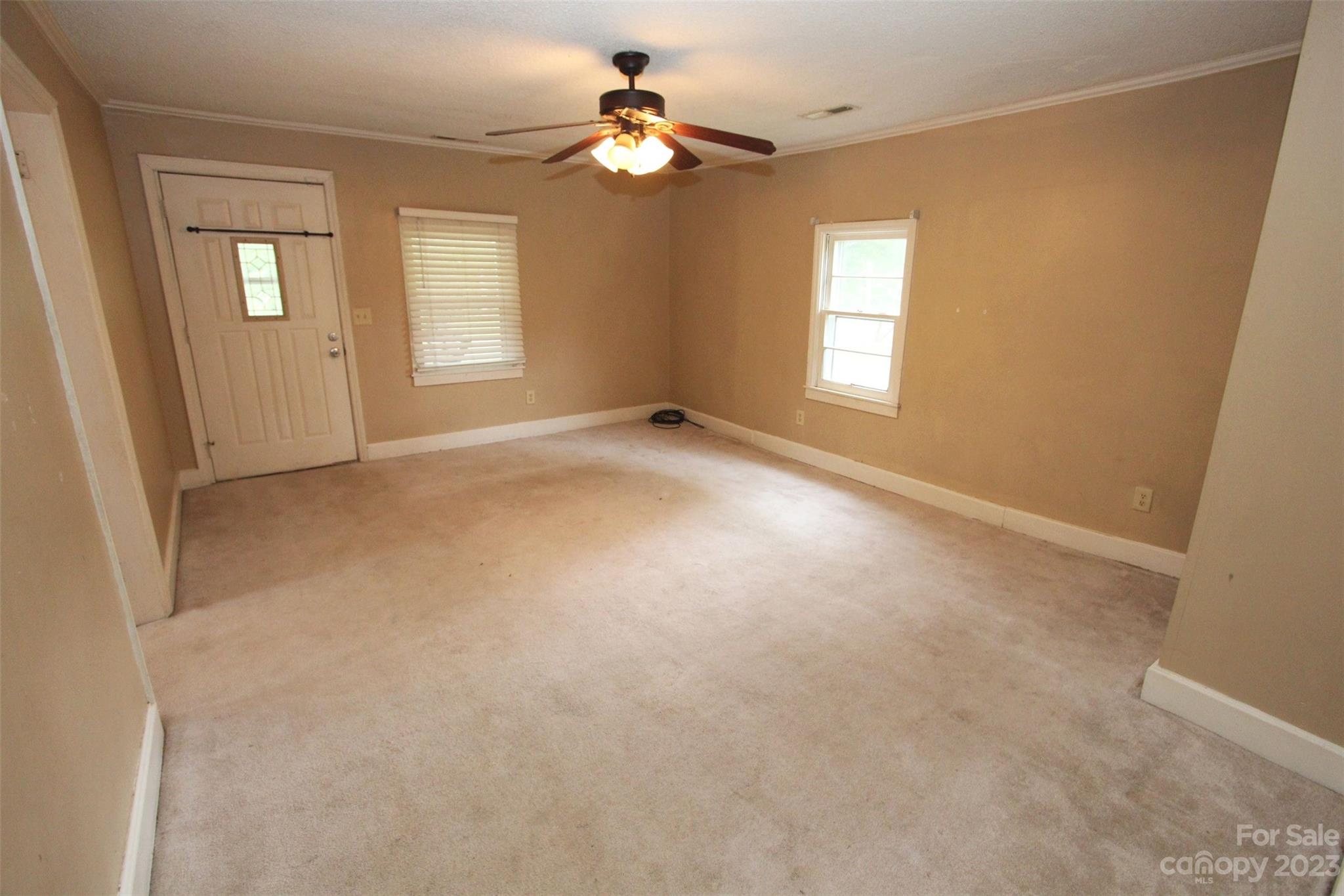 488 Savannah Road Peachland, NC 28133 - Photo 9 of 35 an empty room with windows and fan