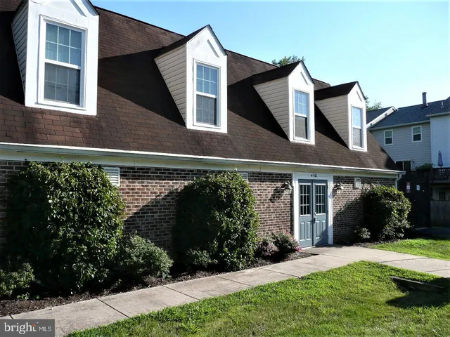 a view of a house with a yard and potted plants