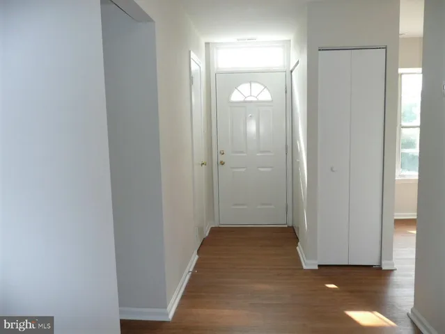 a view of a room with wooden floor