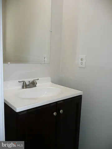 a bathroom with a sink vanity and a toilet