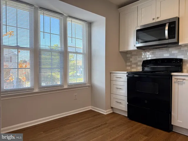 a kitchen with a stove and a microwave