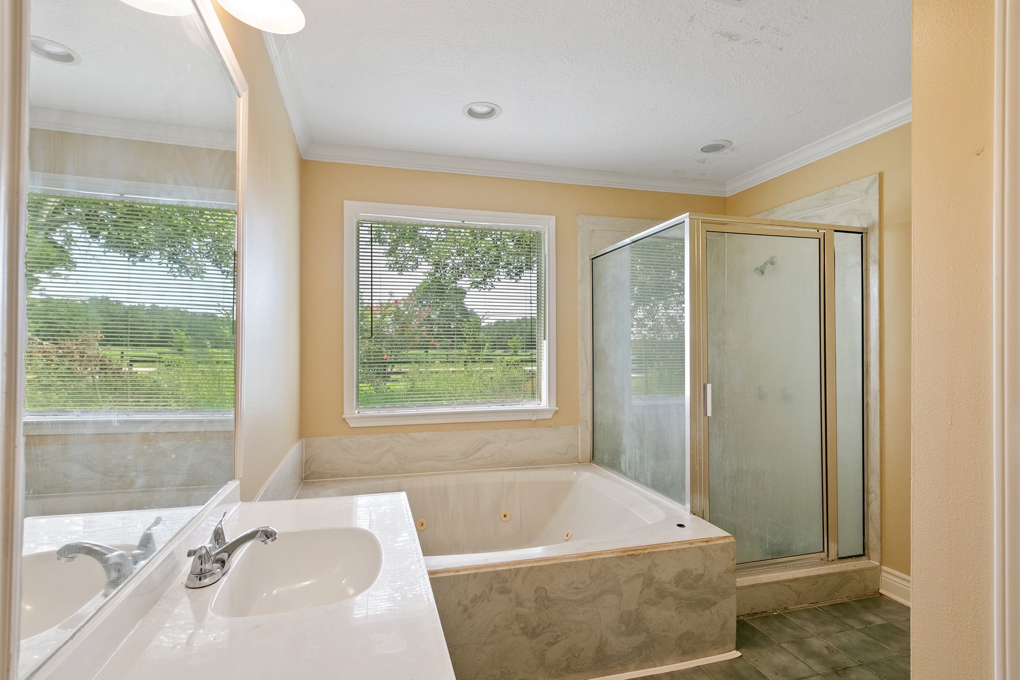 17018 Grant Road Cypress, TX 77429 - Photo 40 of 50 a bath tub sitting in a bathroom next to a window