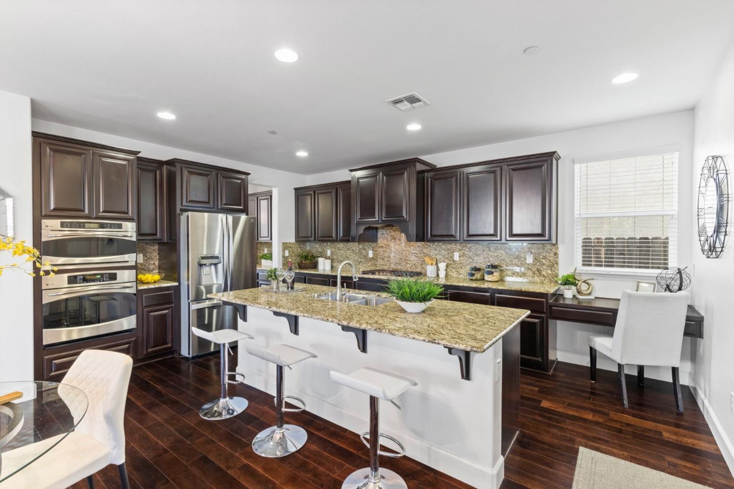 823 Sunrise Drive Gilroy, CA 95020 - Photo 11 of 46 a kitchen with a refrigerator a stove a sink a dining table and chairs