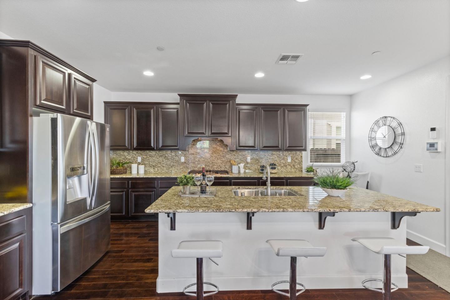 823 Sunrise Drive Gilroy, CA 95020 - Photo 12 of 46 a kitchen with a refrigerator a stove a sink and a cabinets