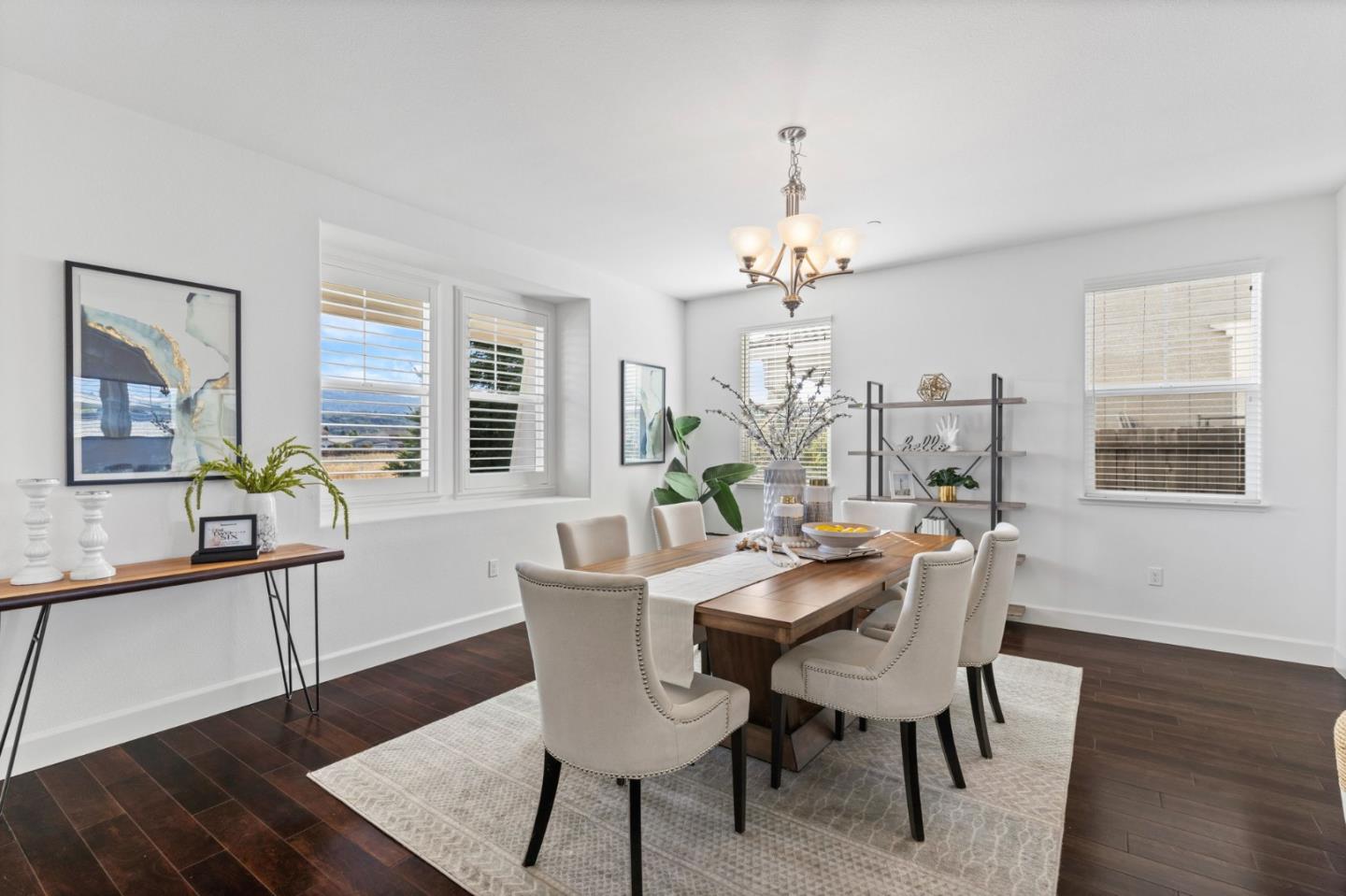 823 Sunrise Drive Gilroy, CA 95020 - Photo 10 of 46 a view of a dining room with furniture a chandelier and wooden floor