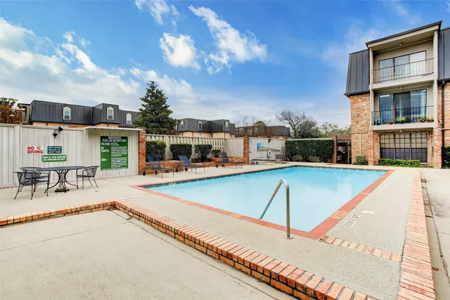 a view of a patio with swimming pool table and chairs
