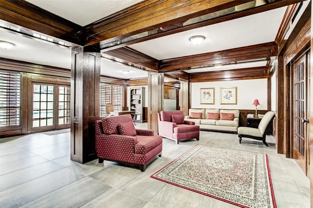 a living room with furniture and a floor to ceiling window