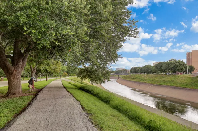 a view of a street with a yard and a fountain