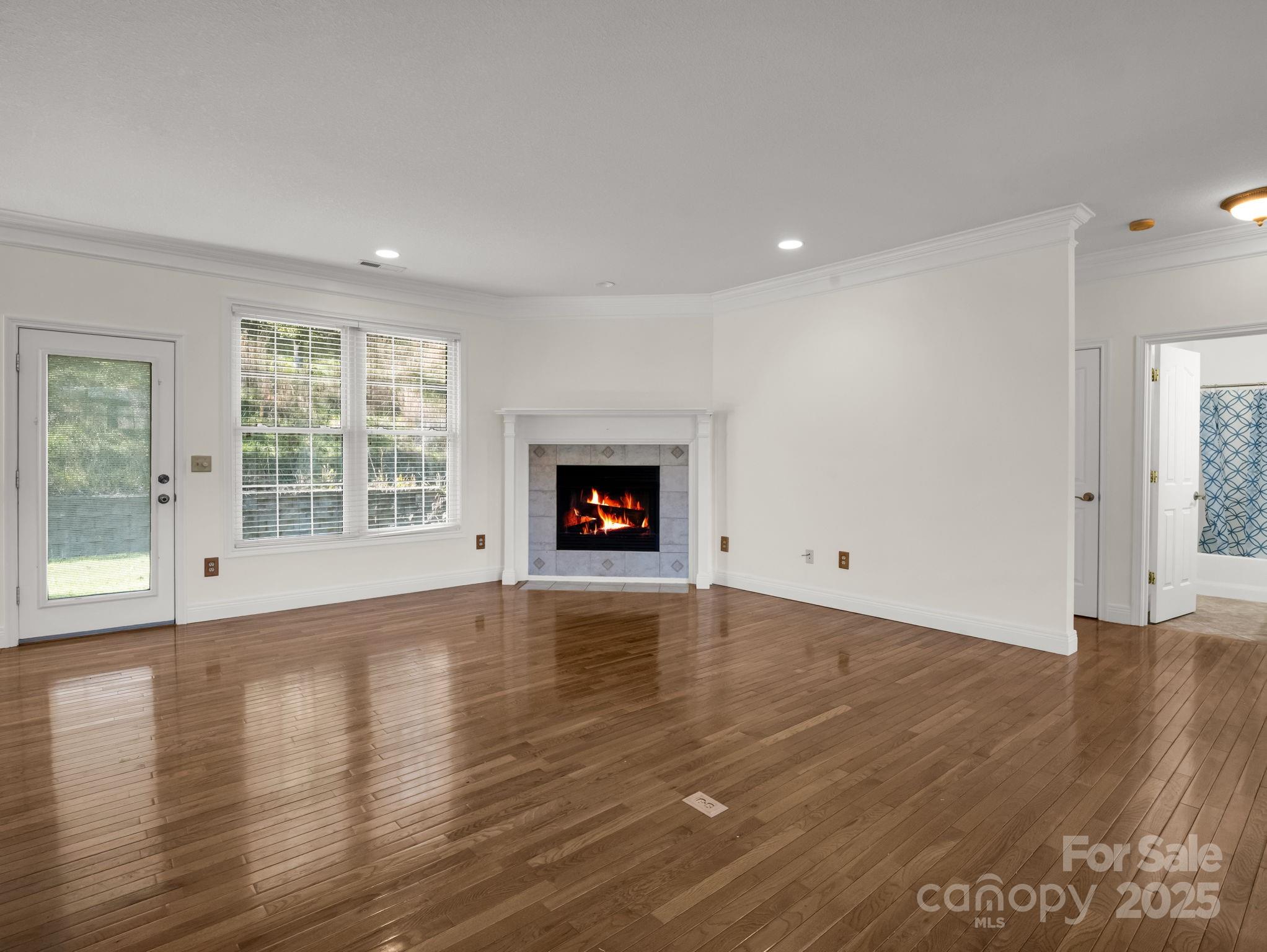 124 Shadow View Drive Leicester, NC 28748 - Photo 12 of 41 an empty room with wooden floor and a window