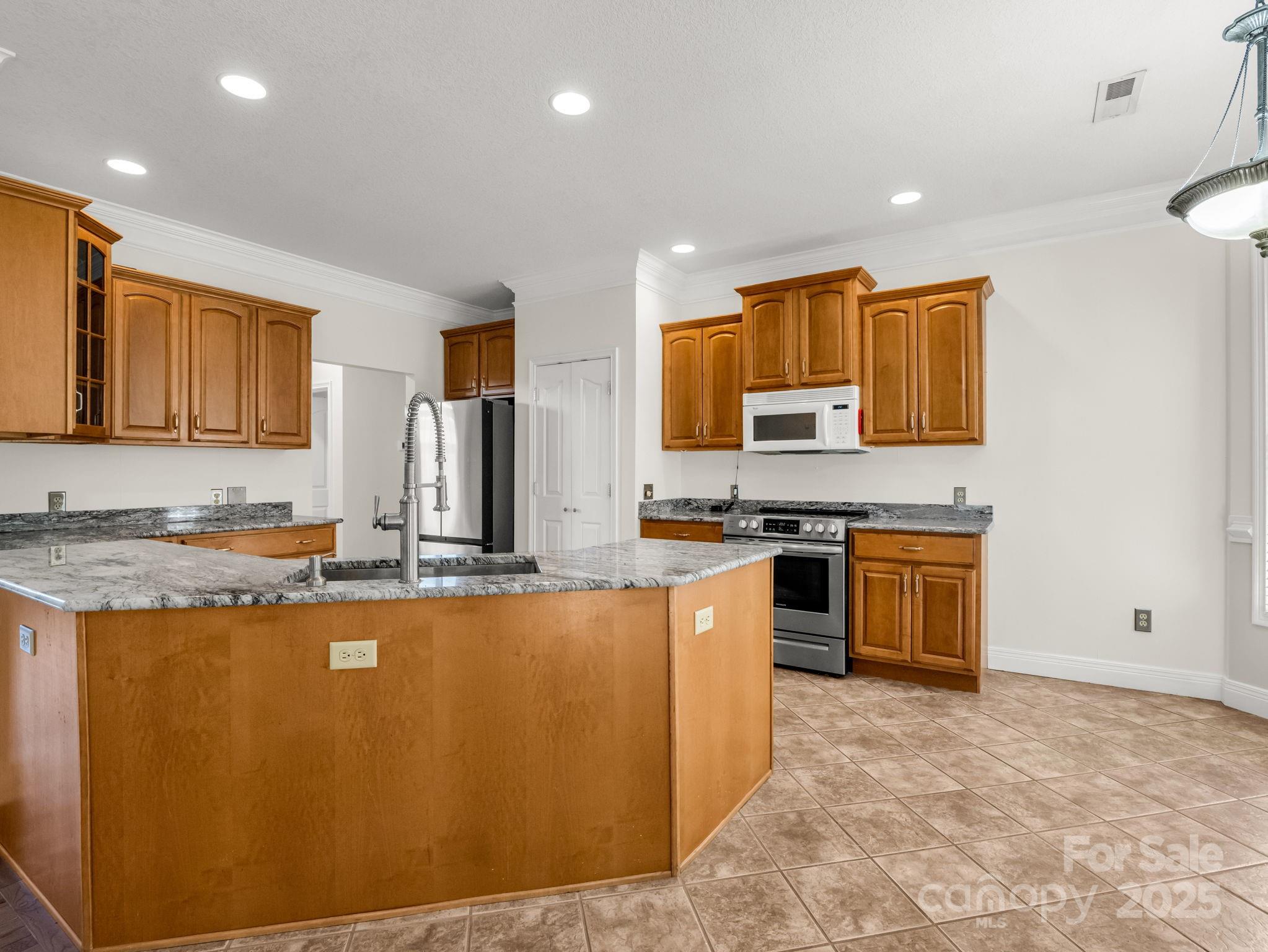124 Shadow View Drive Leicester, NC 28748 - Photo 13 of 41 a large kitchen with stainless steel appliances granite countertop a stove a sink and a refrigerator