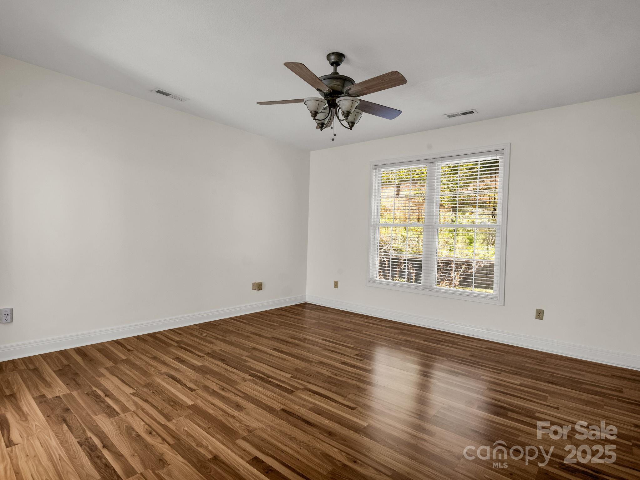 124 Shadow View Drive Leicester, NC 28748 - Photo 20 of 41 a view of an empty room with wooden floor and a window