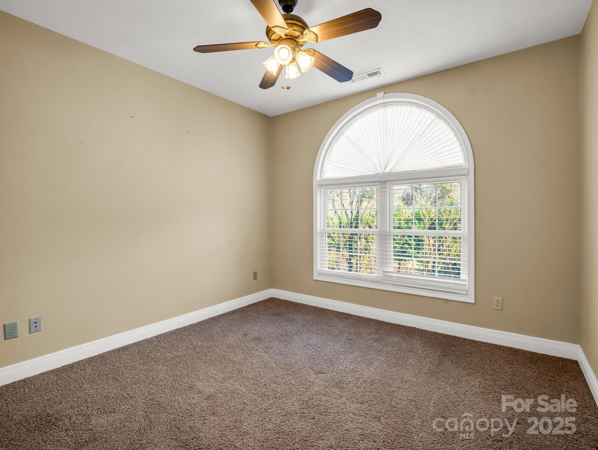 124 Shadow View Drive Leicester, NC 28748 - Photo 27 of 41 an empty room with a window and a fan
