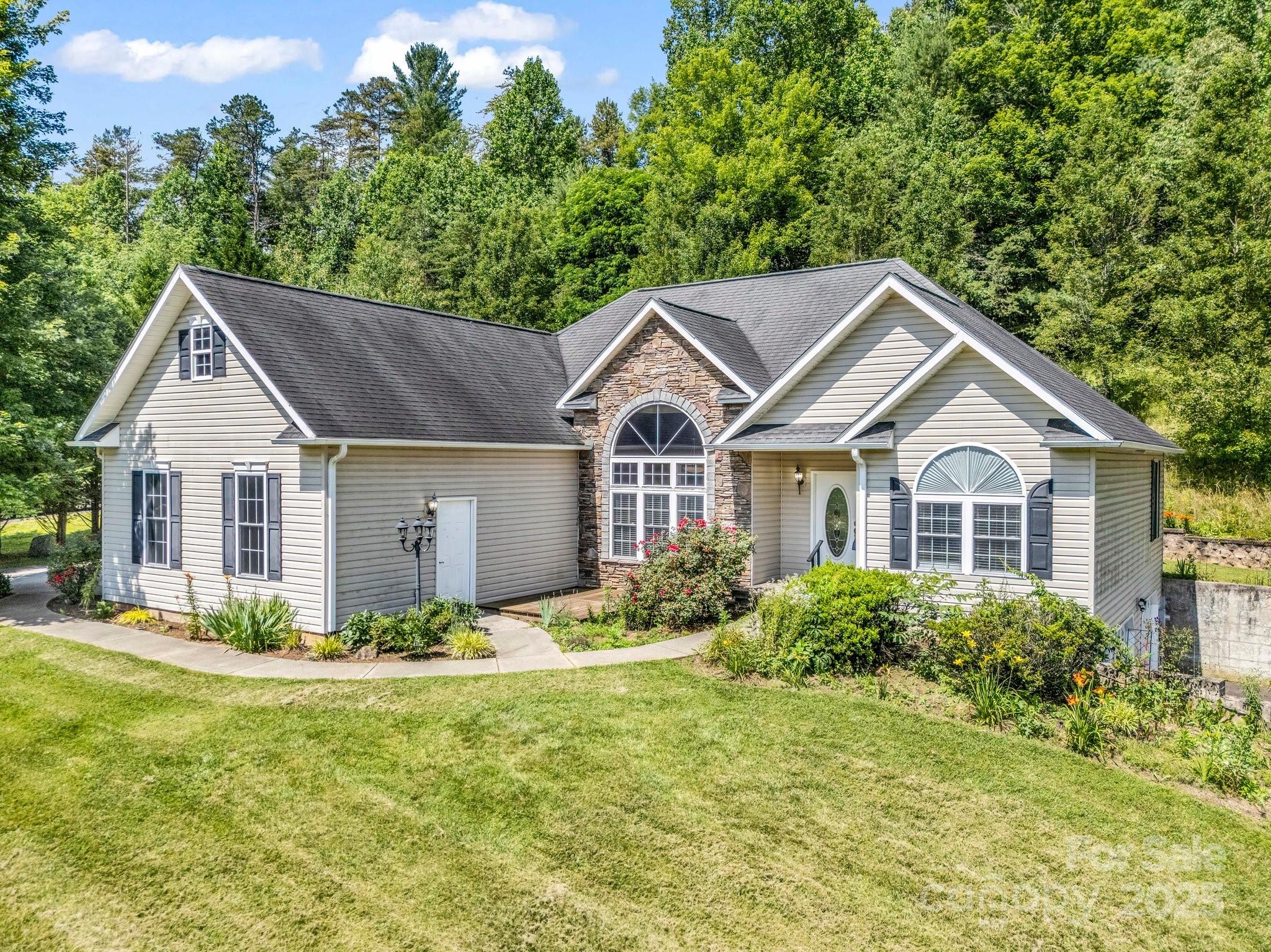 124 Shadow View Drive Leicester, NC 28748 - Photo 7 of 41 a front view of a house with a yard and trees