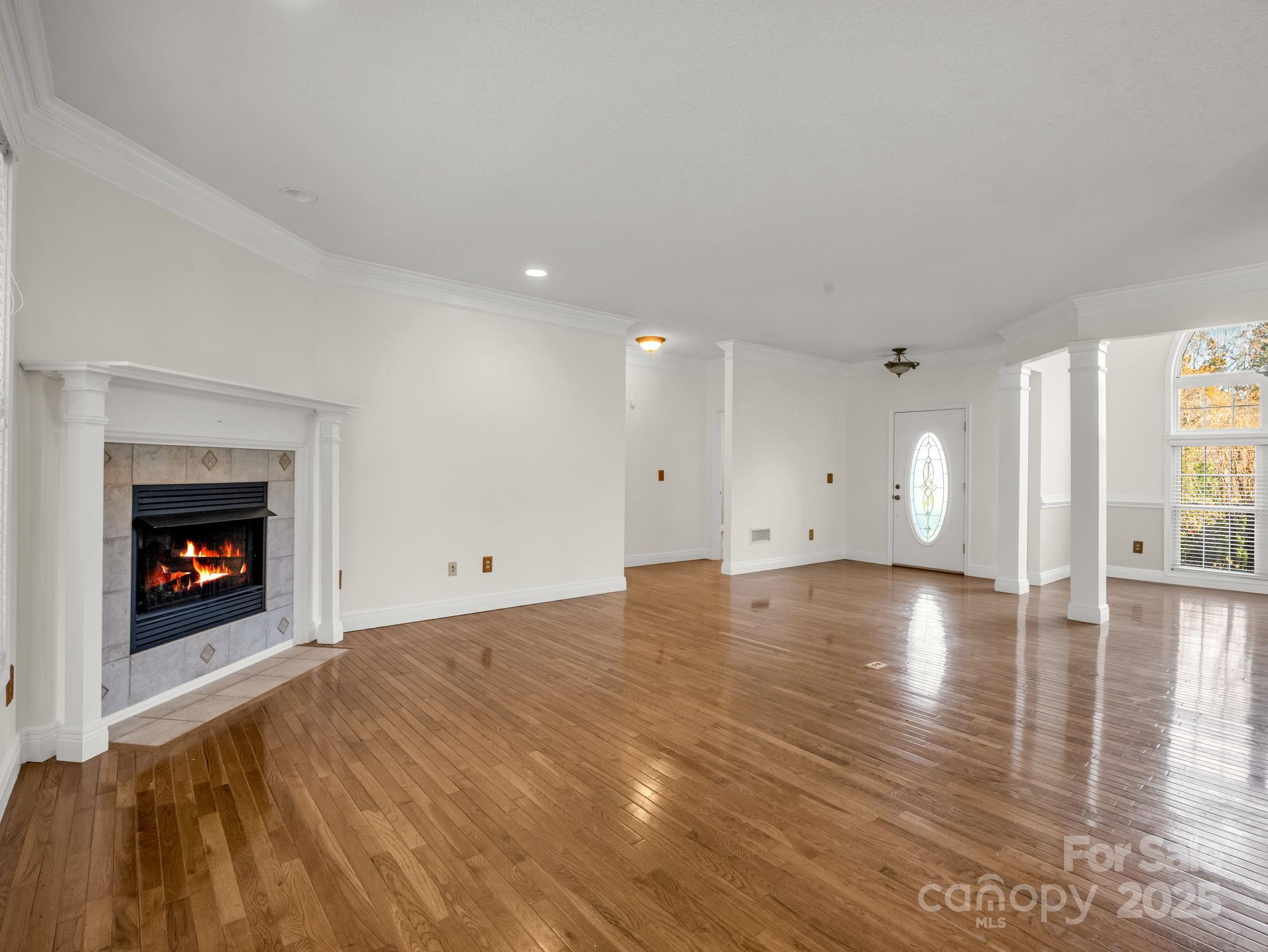 124 Shadow View Drive Leicester, NC 28748 - Photo 8 of 41 a view of empty room with wooden floor and fireplace