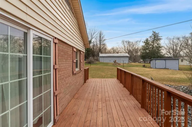 a view of balcony with wooden floor and fence