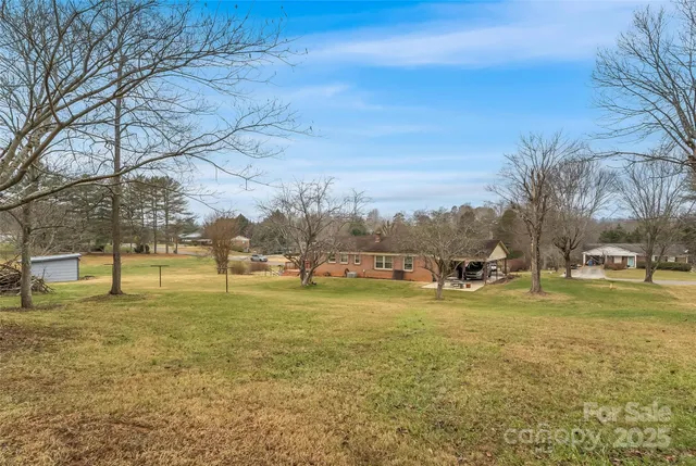 a view of yard with swimming pool and trees