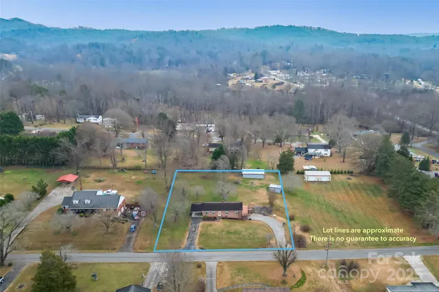 an aerial view of a house with a big yard