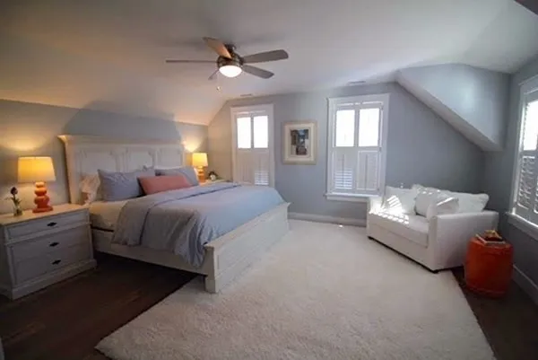 a spacious bedroom with a bed and a chandelier