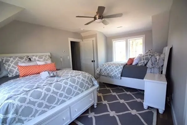 a bedroom with a large bed and a chandelier