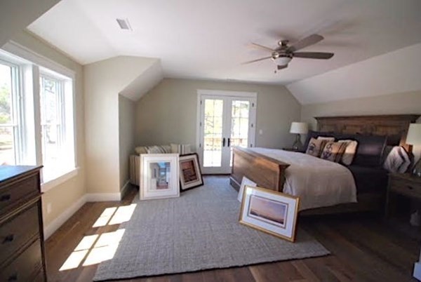 7 Mill Hill Farms Road Edgartown, MA 02539 - Photo 15 of 25 a spacious bedroom with a bed and a chandelier
