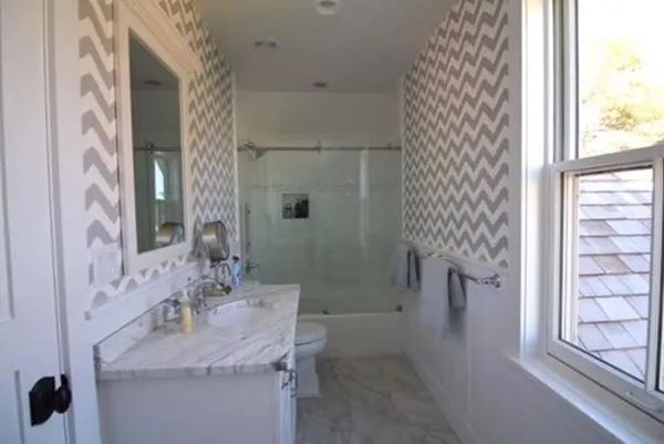 a bathroom with a granite countertop sink a toilet and shower