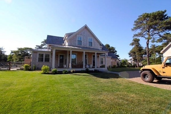 7 Mill Hill Farms Road Edgartown, MA 02539 - Photo 23 of 25 a front view of a house with a garden and trees