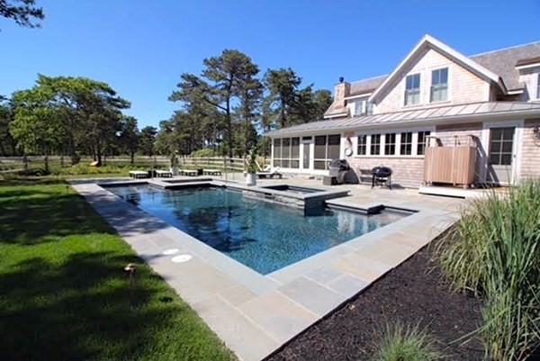 7 Mill Hill Farms Road Edgartown, MA 02539 - Photo 24 of 25 a view of a white house with a yard table and chairs