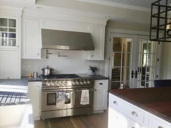 a kitchen with stainless steel appliances a stove and a microwave
