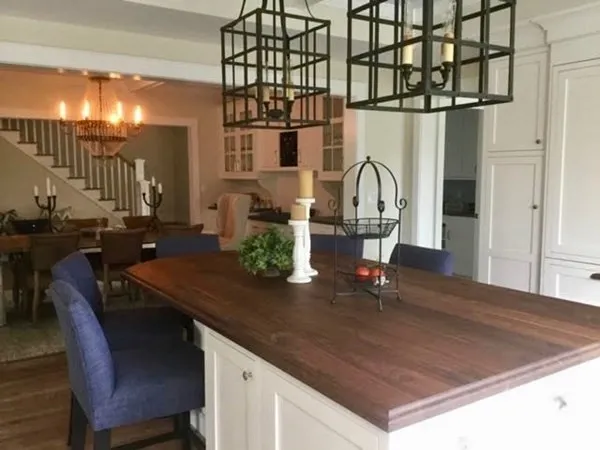 a kitchen with a table chairs and cabinets