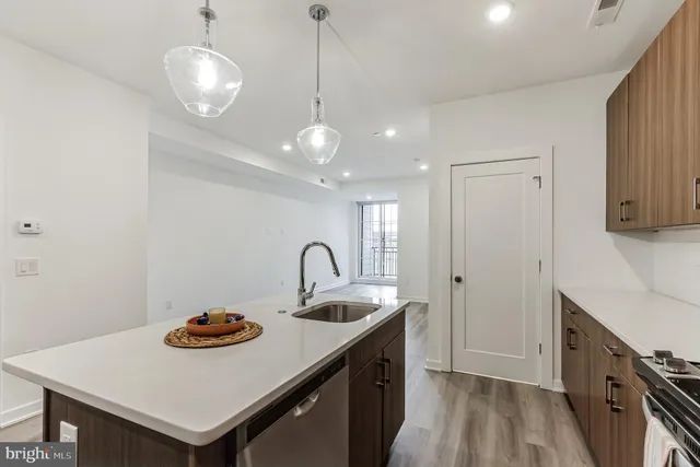 a kitchen with a sink a stove and kitchen island