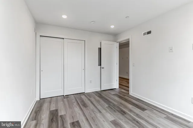 a view of hallway with wooden floor