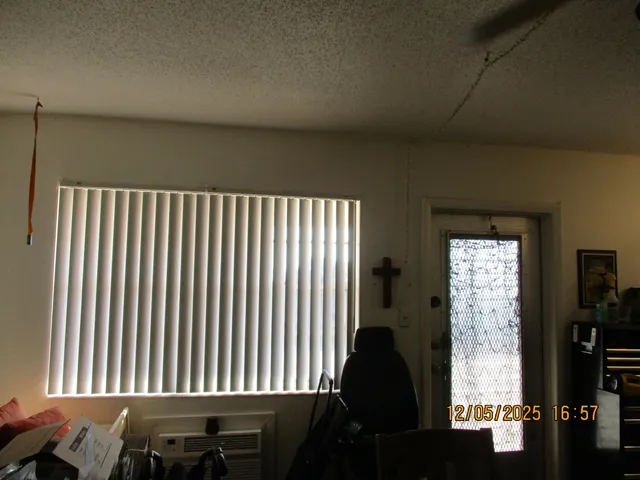 a room with a baby crib and a wooden floor