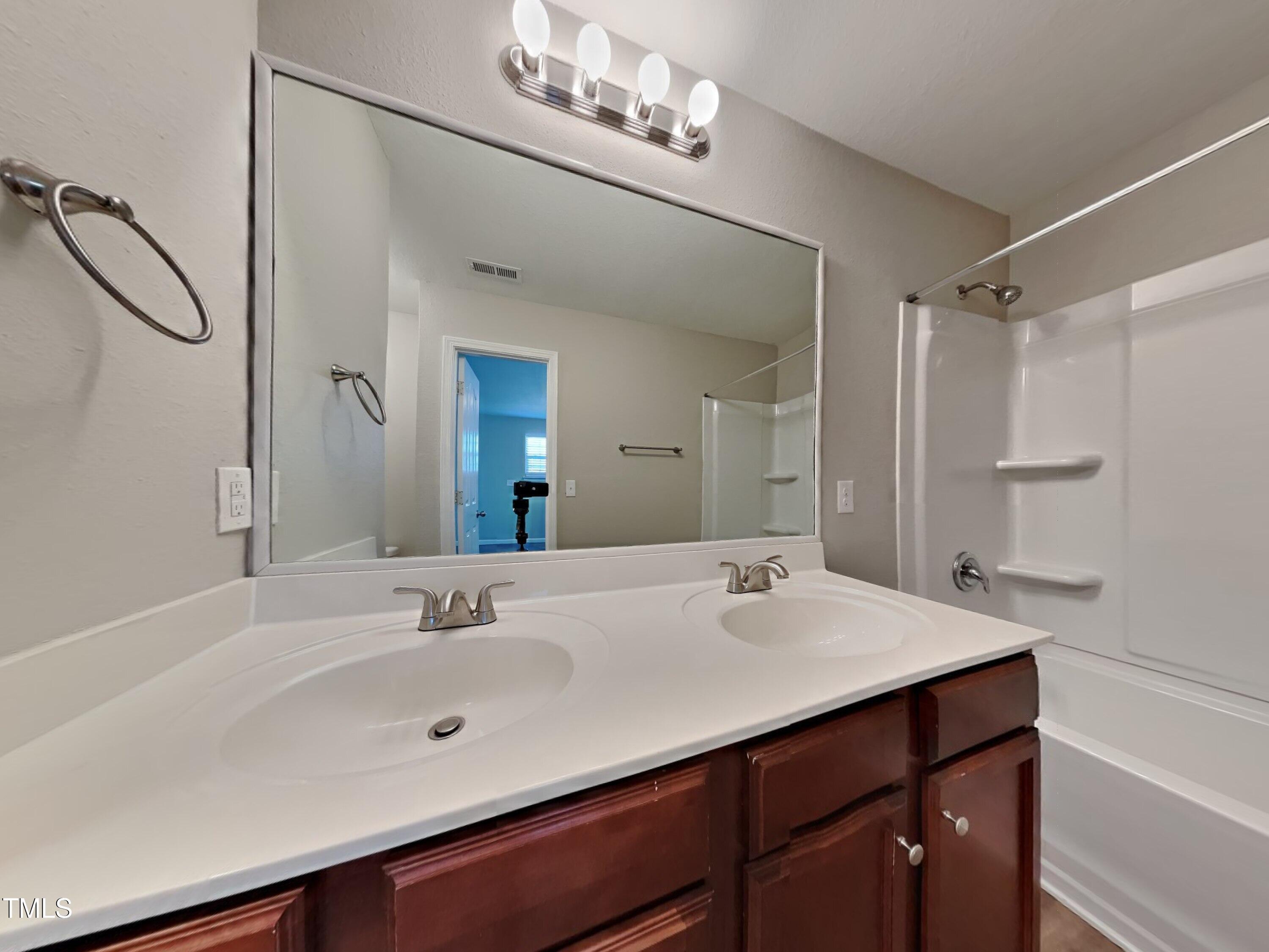 244 Botanical Court Bunnlevel, NC 28323 - Photo 14 of 18 a bathroom with a sink double vanity and a mirror