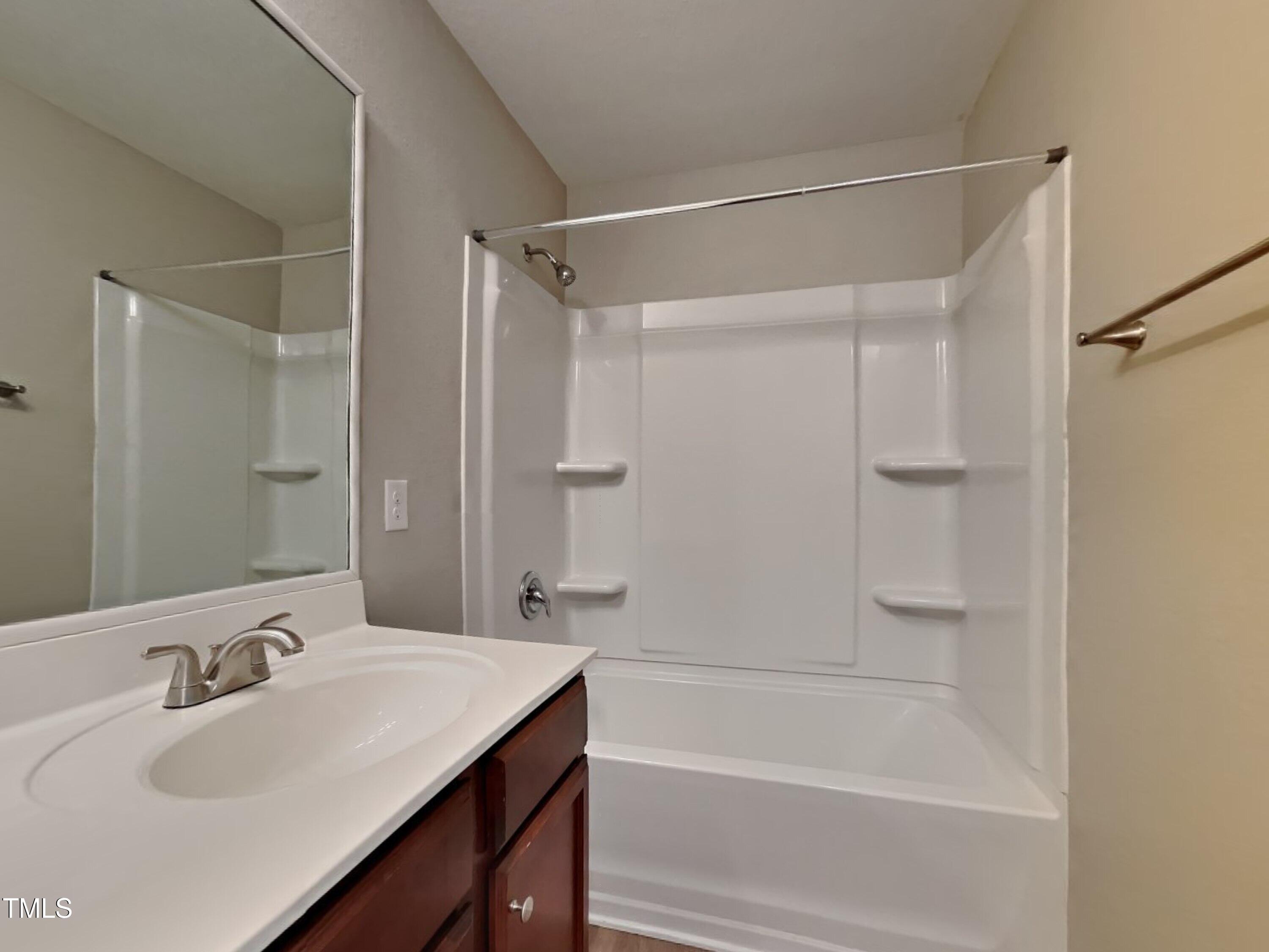 244 Botanical Court Bunnlevel, NC 28323 - Photo 15 of 18 a bathroom with a sink and a mirror