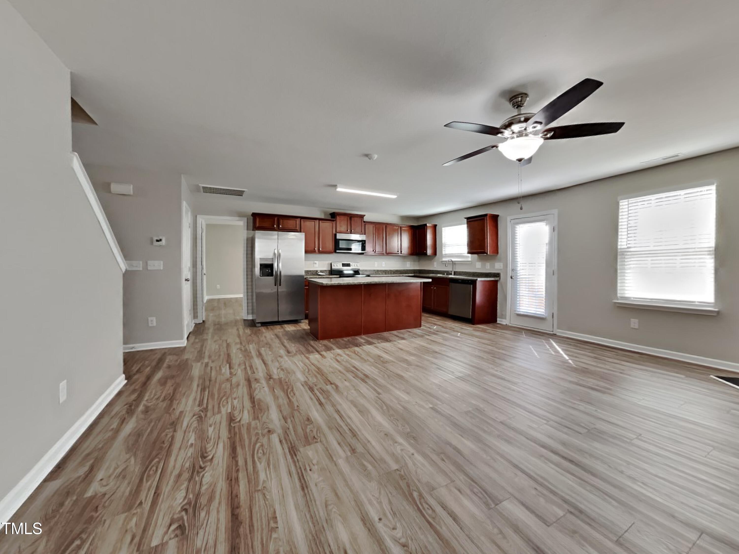244 Botanical Court Bunnlevel, NC 28323 - Photo 3 of 18 a living room with stainless steel appliances kitchen island hardwood floor and a window