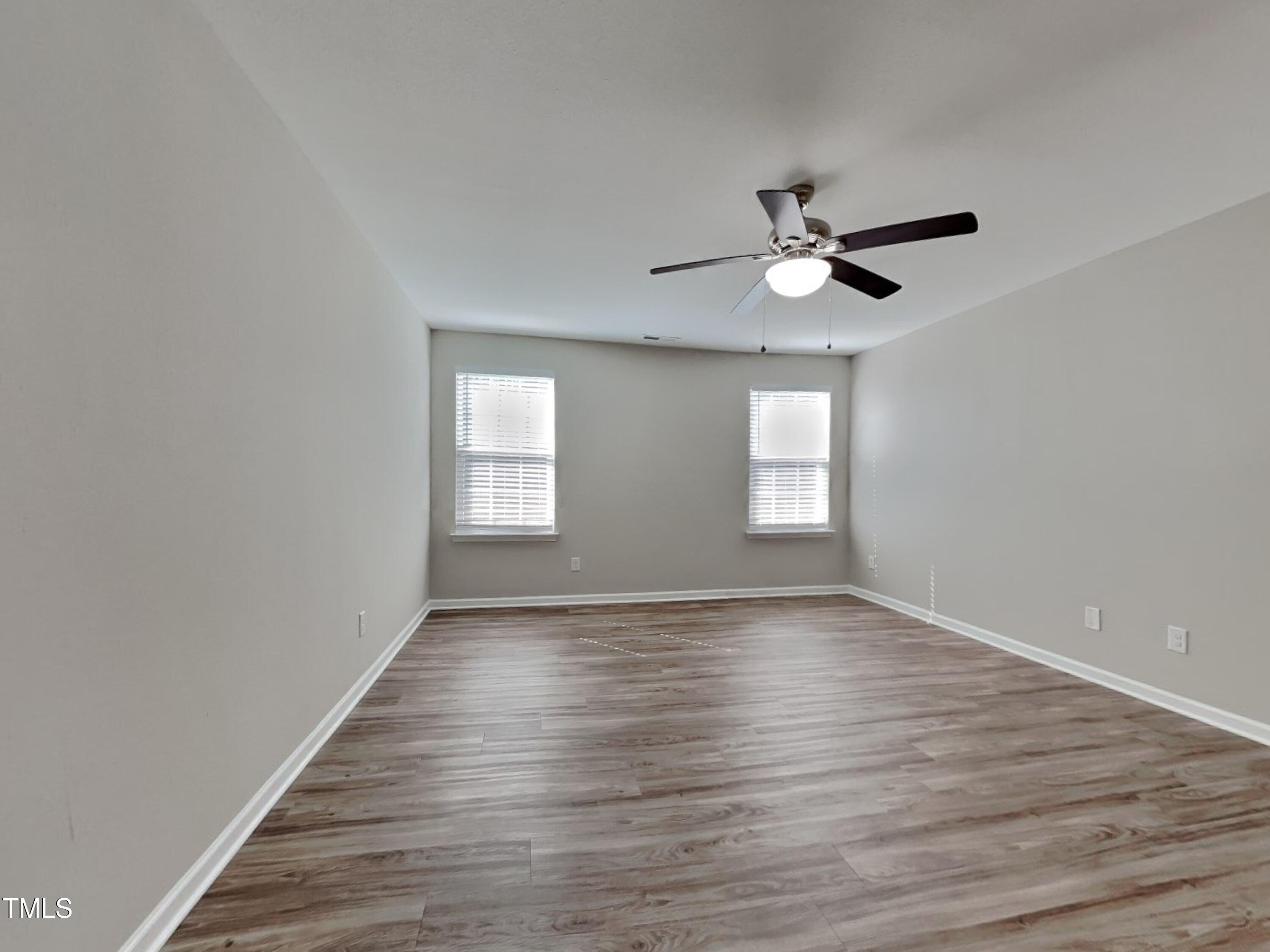 244 Botanical Court Bunnlevel, NC 28323 - Photo 5 of 18 a view of empty room with wooden floor and fan