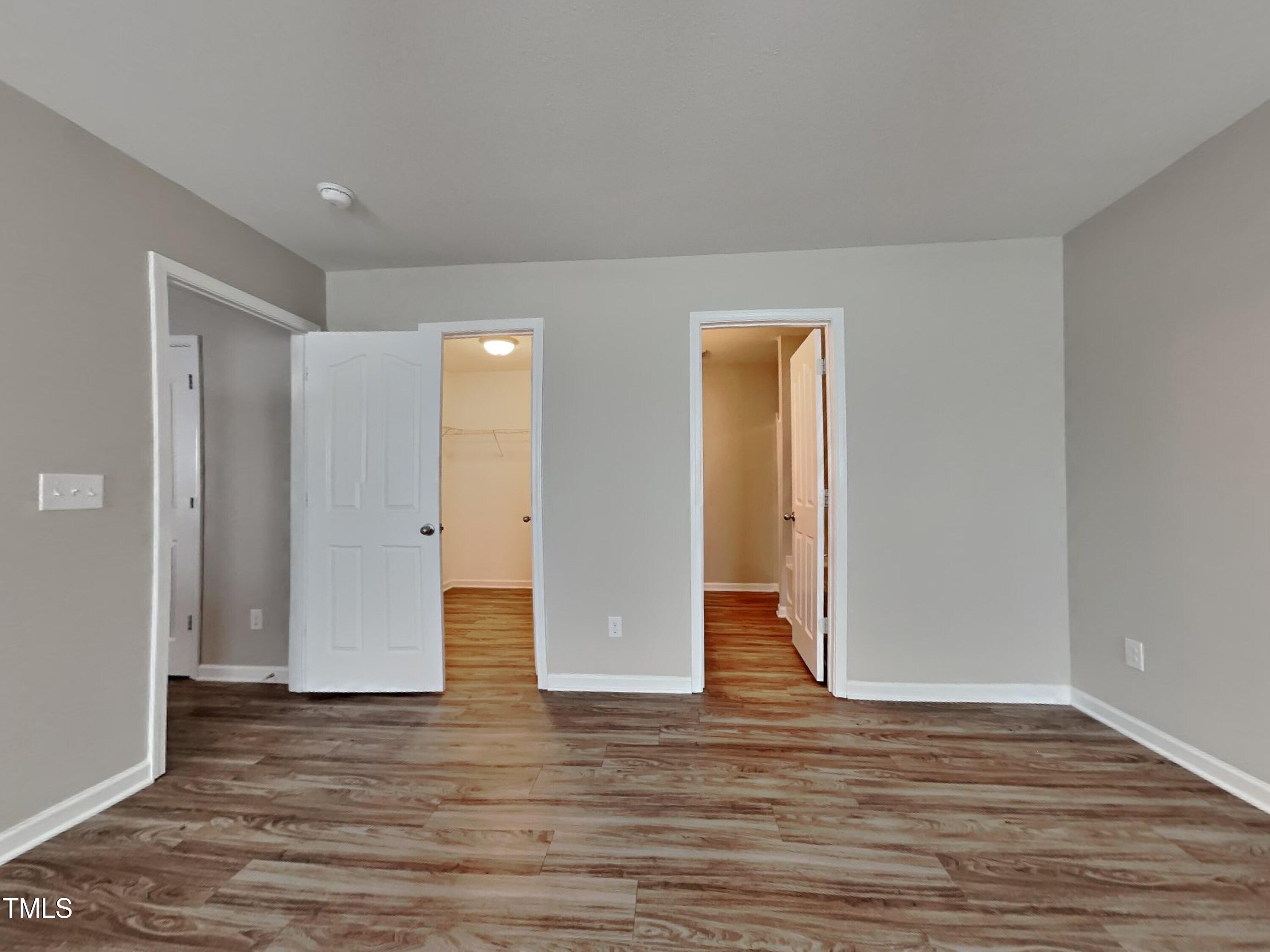 244 Botanical Court Bunnlevel, NC 28323 - Photo 6 of 18 a view of an empty room with wooden floor and closet
