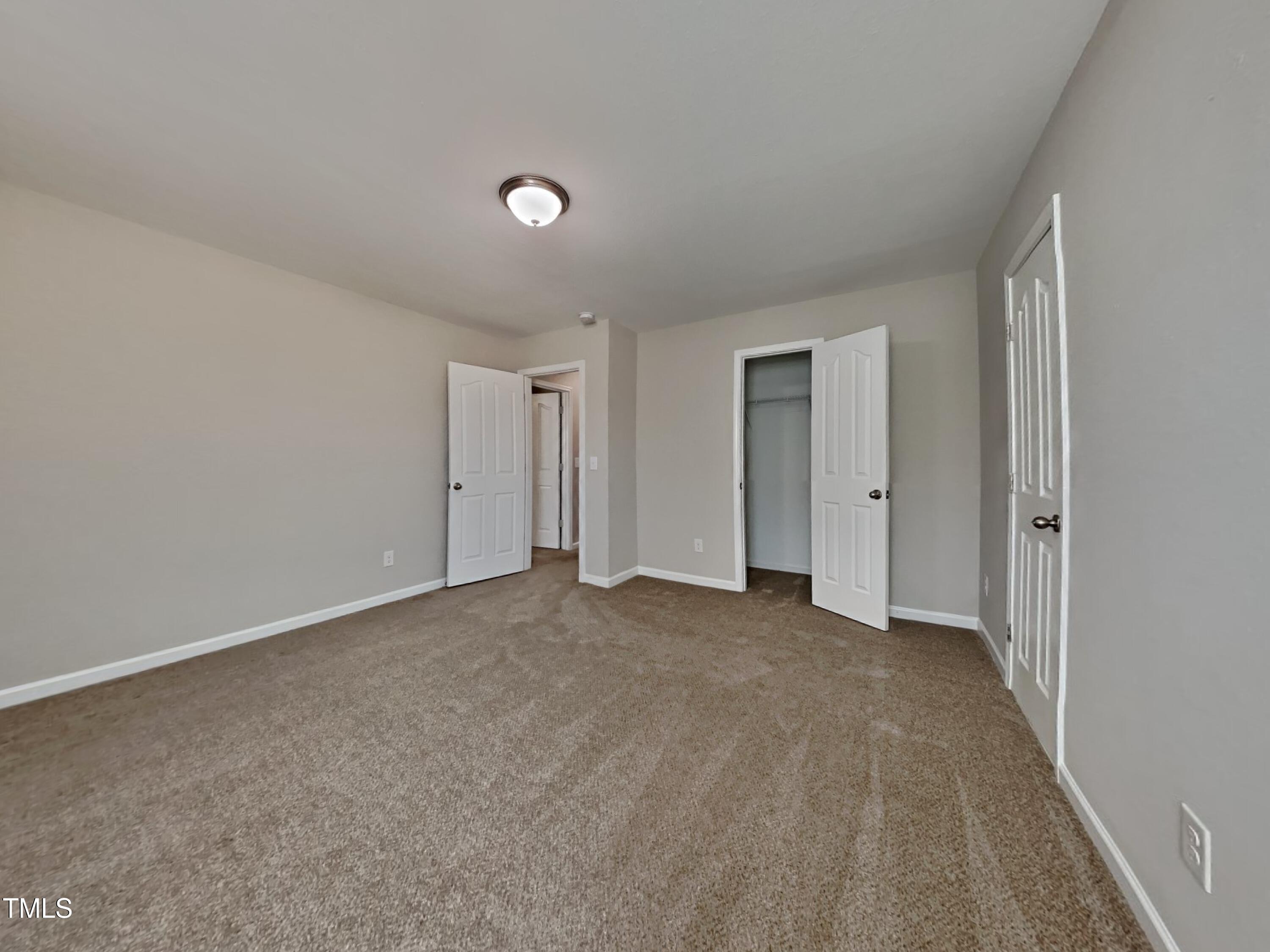 244 Botanical Court Bunnlevel, NC 28323 - Photo 9 of 18 a view of an empty room and closet area
